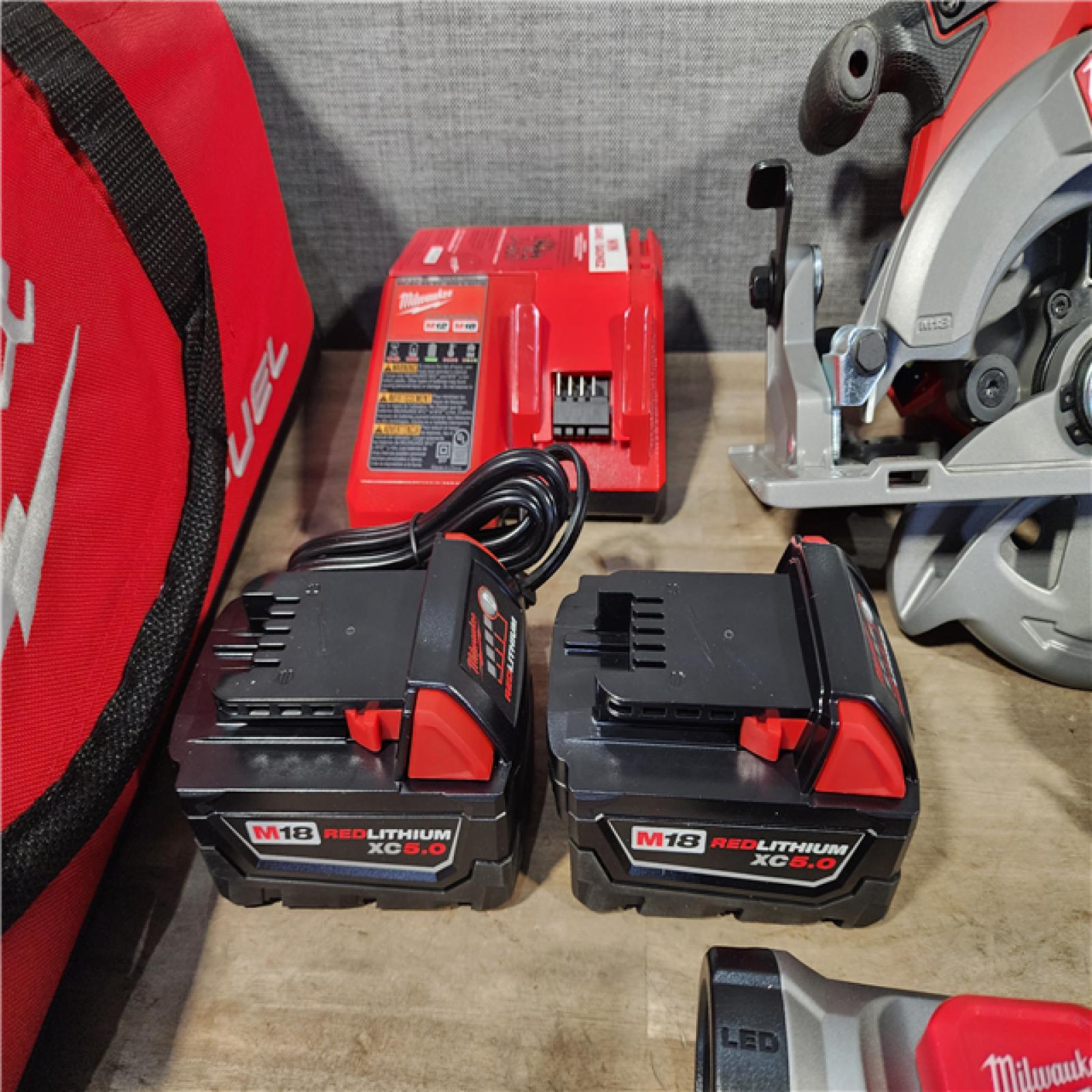 HOUSTON LOCATION - AS-IS (APPEARS LIKE NEW) Milwaukee M18 FUEL 18V Lithium-Ion Brushless Cordless Combo Kit with Two 5.0 Ah Batteries  1 Charger  2 Tool Bags (7-Tool)