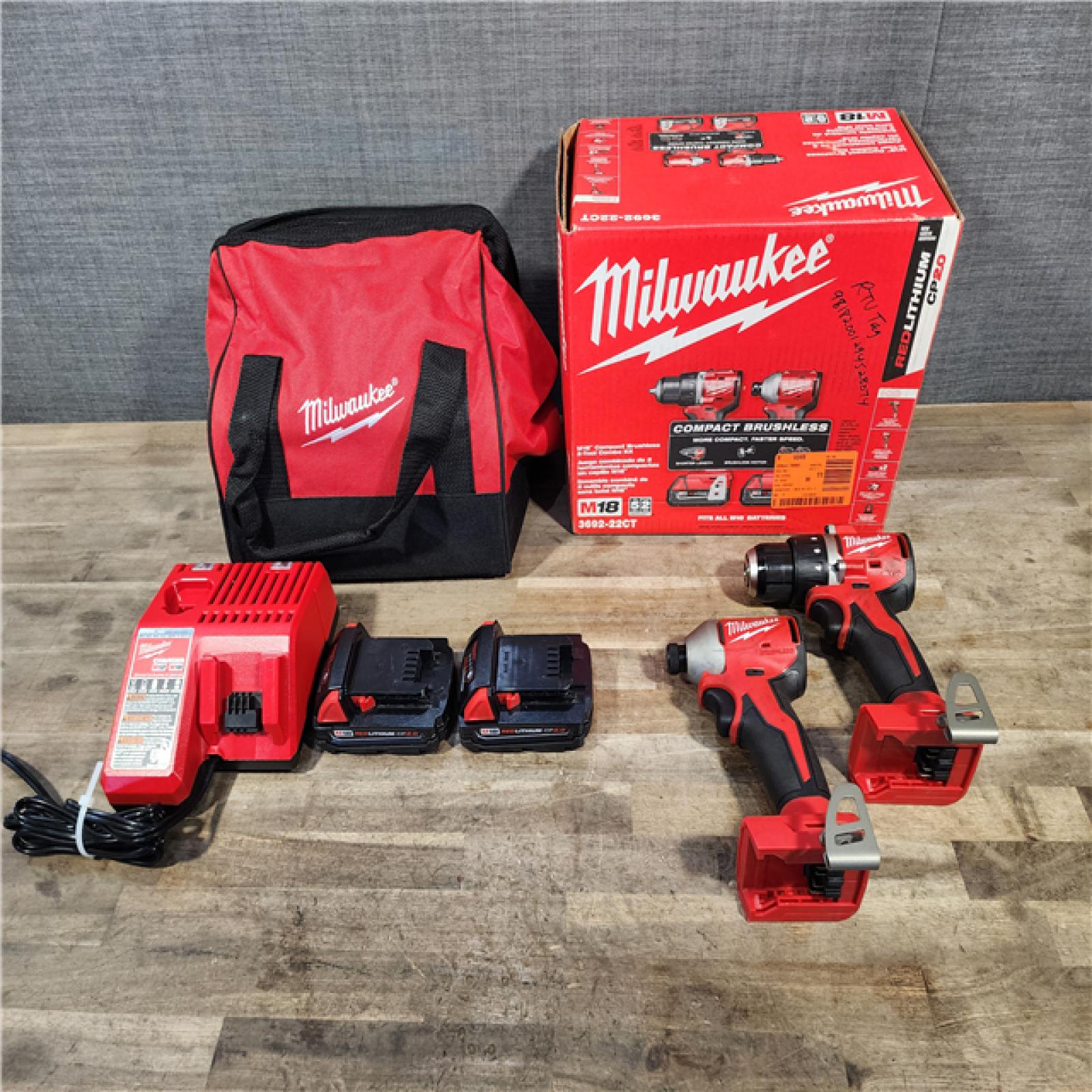 HOUSTON LOCATION - AS-IS Milwaukee M18 18V Lithium-Ion Brushless Cordless Compact Drill/Impact Combo Kit (2-Tool) W/(2) 2.0 Ah Batteries  Charger & Bag