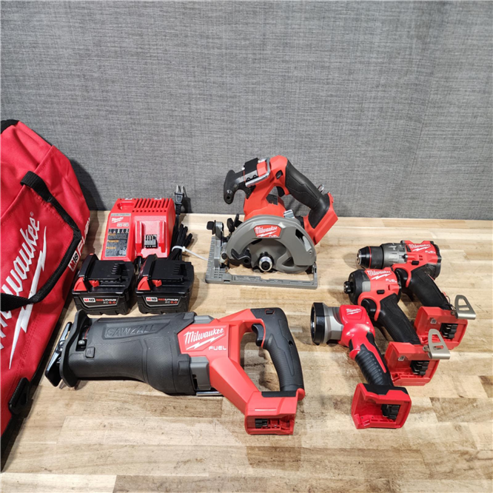 HOUSTON LOCATION - AS-IS (APPEARS LIKE NEW) Milwaukee M18 FUEL 18V Lithium-Ion Brushless Cordless 5-Tool Combo Kit with Two 5.0 Ah Batteries  1 Charger 1 Tool Bag