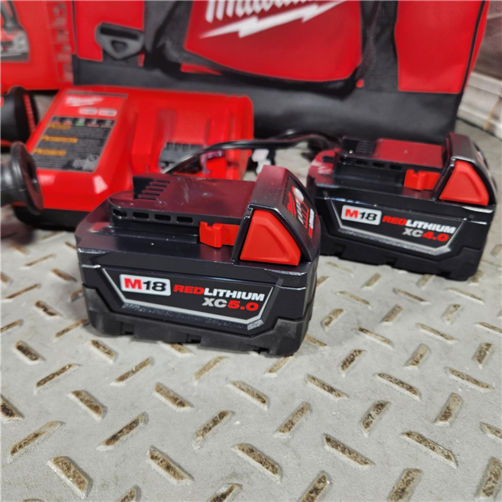 Houston location- AS-IS Milwaukee 2992-22 18V M18 Lithium-Ion Brushless Cordless 2-Tool Combo Kit with 1/2 Hammer Drill/Driver and 7-1/4 Circular Saw 4.0 Ah
