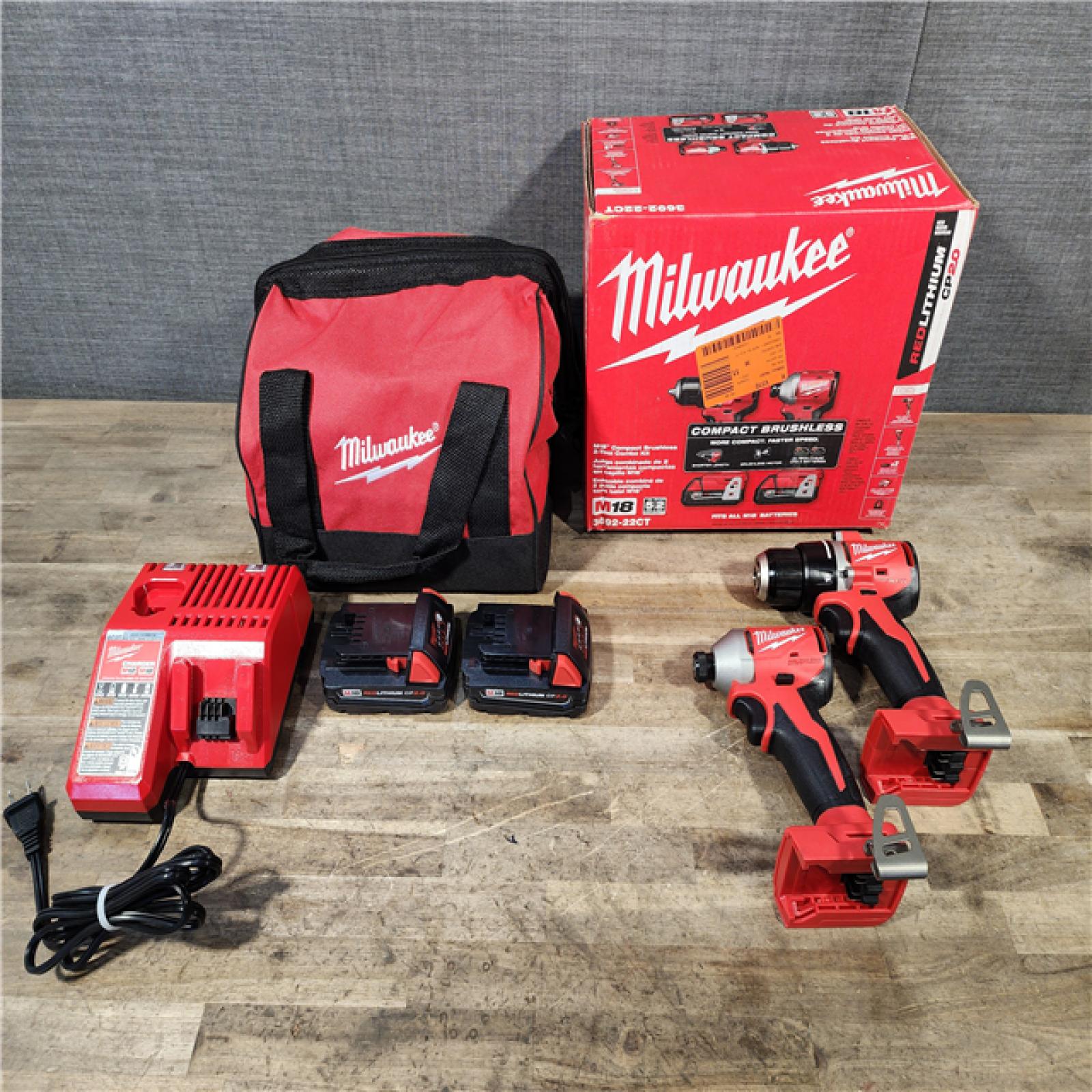 HOUSTON LOCATION - AS-IS Milwaukee M18 18V Lithium-Ion Brushless Cordless Compact Drill/Impact Combo Kit (2-Tool) W/(2) 2.0 Ah Batteries  Charger & Bag