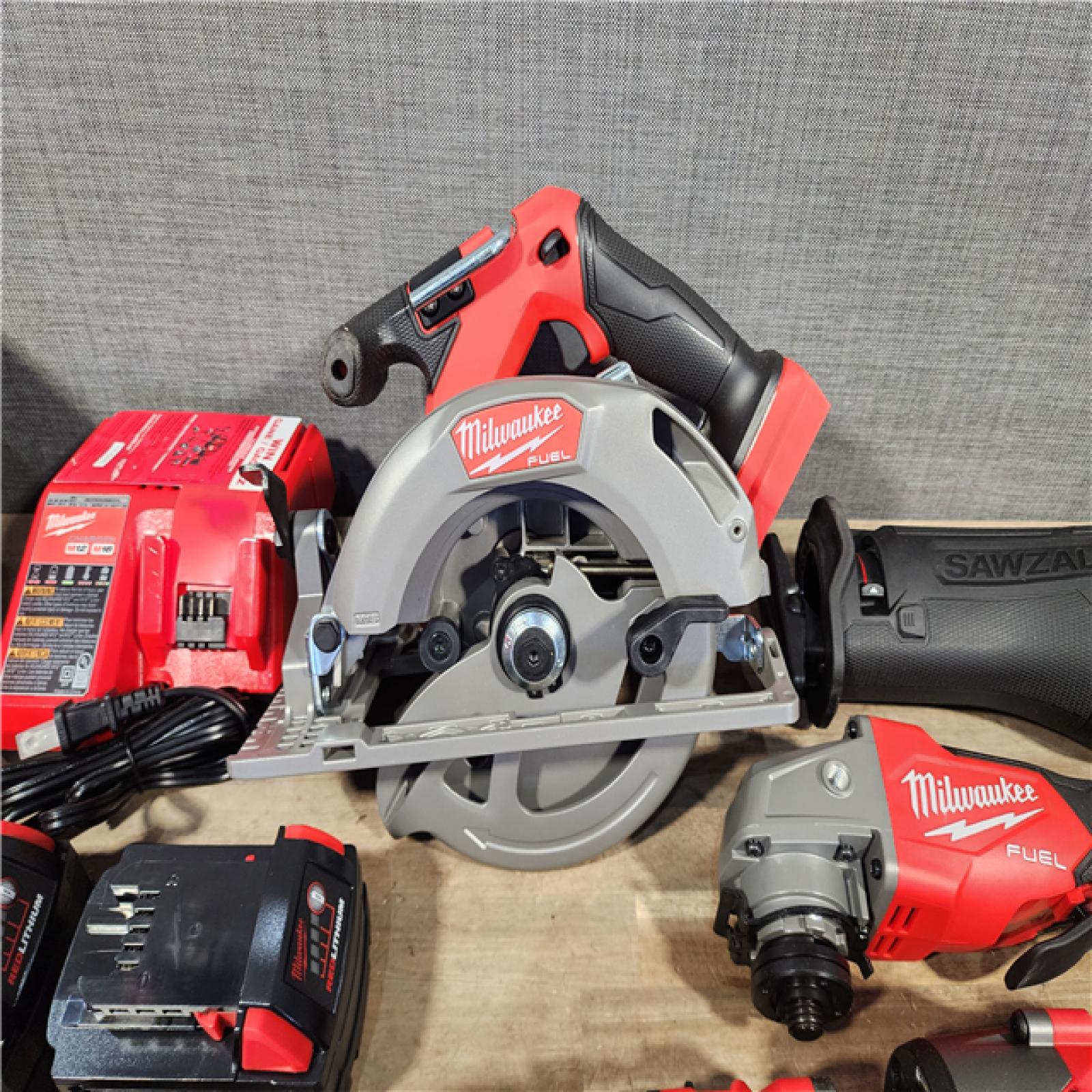 HOUSTON LOCATION - AS-IS (APPEARS LIKE NEW) Milwaukee M18 FUEL 18V Lithium-Ion Brushless Cordless Combo Kit with Two 5.0 Ah Batteries  1 Charger  2 Tool Bags (7-Tool)