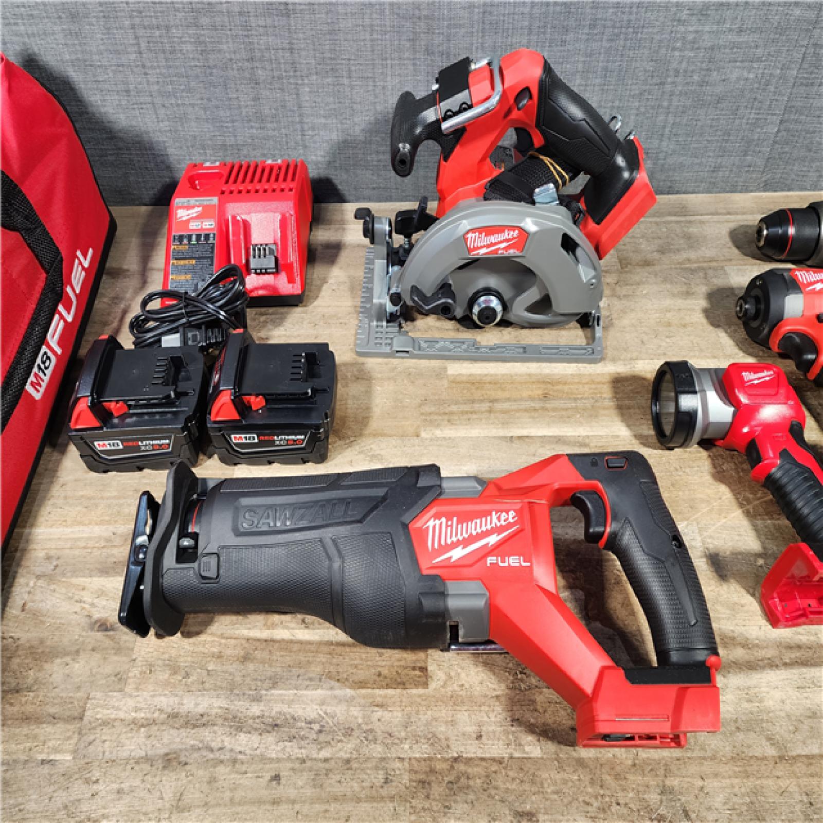 HOUSTON LOCATION - AS-IS (APPEARS LIKE NEW) M18 FUEL 18V Lithium-Ion Brushless Cordless 5-Tool Combo Kit with Two 5.0 Ah Batteries  1 Charger 1 Tool Bag