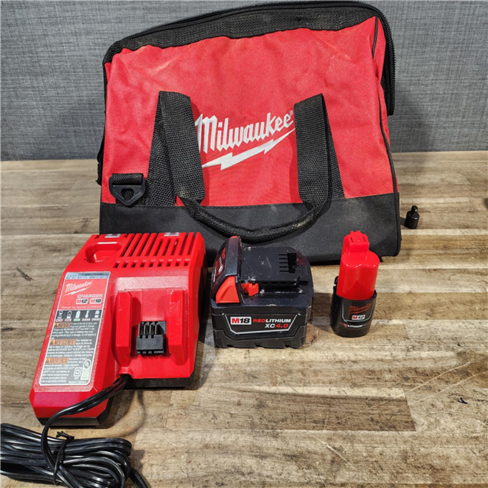 HOUSTON LOCATION - AS-IS Milwaukee 12/18V Lithium-Ion Cordless 3/8 in. Ratchet and 1/2 in. High Torque Impact Wrench with Friction Ring Combo Kit