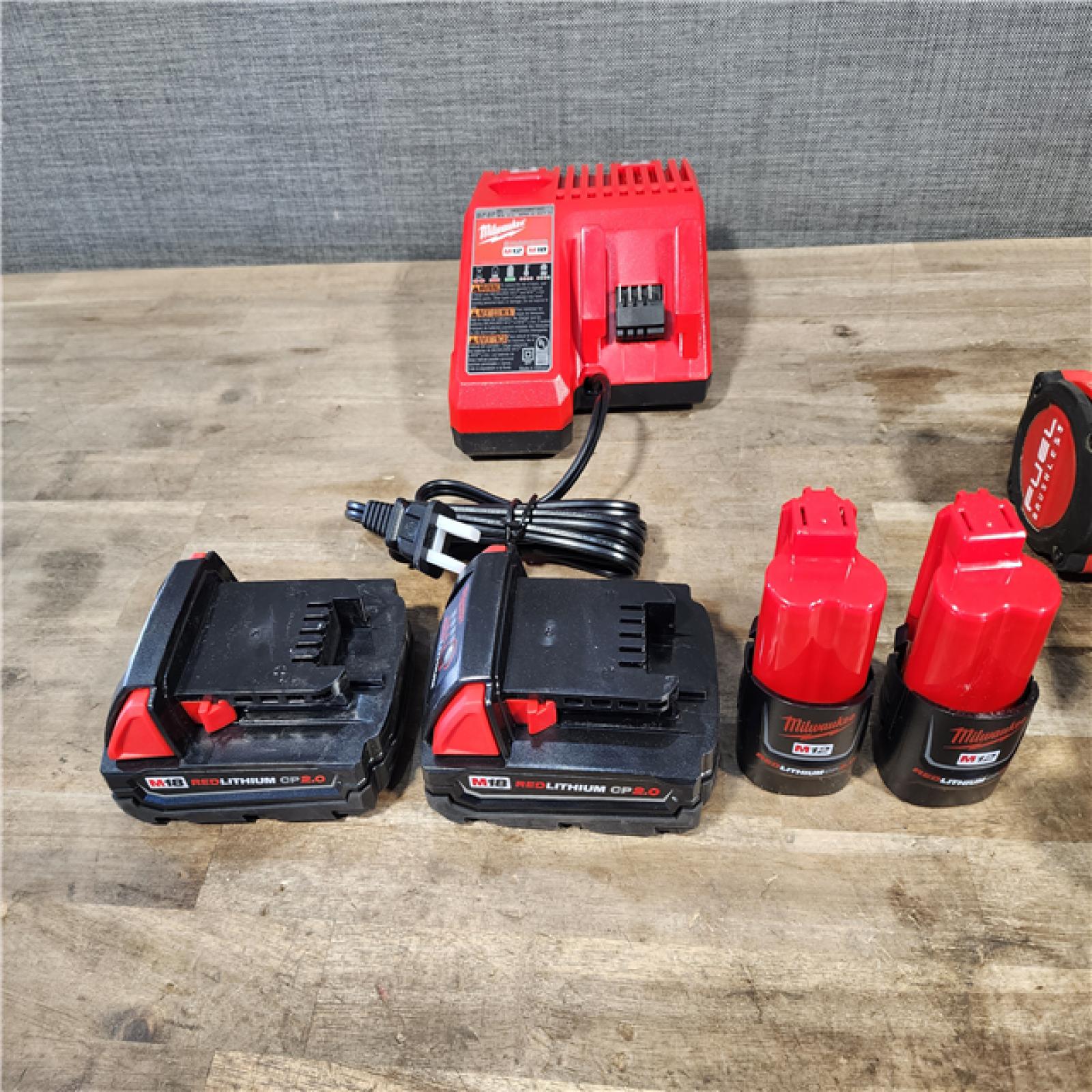 HOUSTON LOCATION - AS-IS MILWAUKEE 4 TOOL COMBO KIT W/ (4) BATTERY & CHARGER