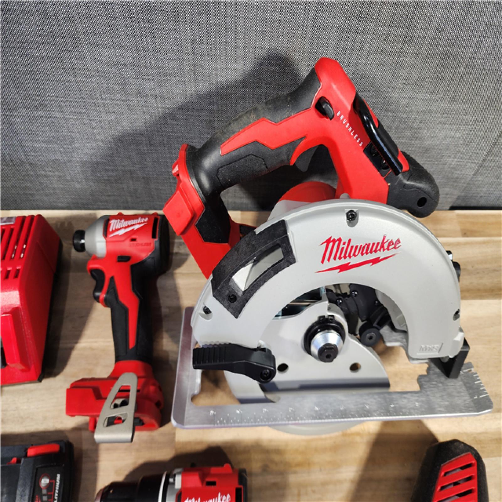 HOUSTON LOCATION - AS-IS Milwaukee M18 18-Volt Lithium-Ion Brushless Cordless Combo Kit (4-Tool) with 2-Batteries, 1-Charger and Tool Bag