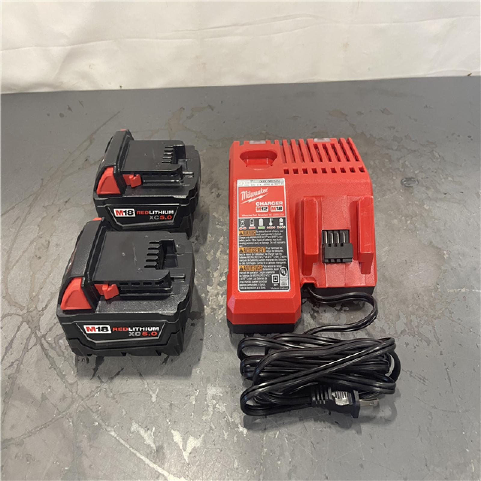 AS-IS- Milwaukee M18 18-Volt Lithium-Ion XC Starter Kit with Two 5.0Ah Batteries and Charger