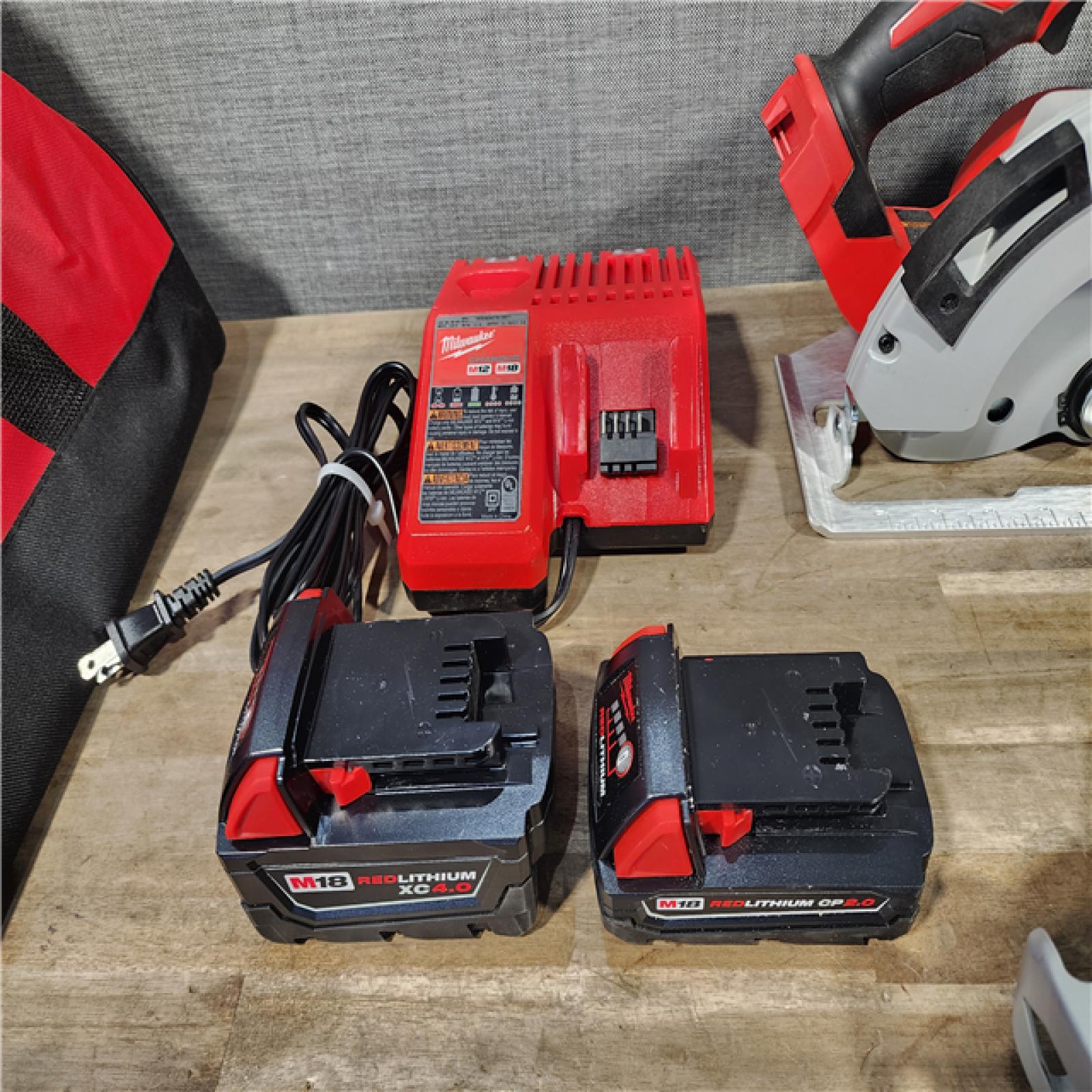 HOUSTON LOCATION - AS-IS Milwaukee M18 18-Volt Lithium-Ion Brushless Cordless Combo Kit (4-Tool) with 2-Batteries  1-Charger and Tool Bag