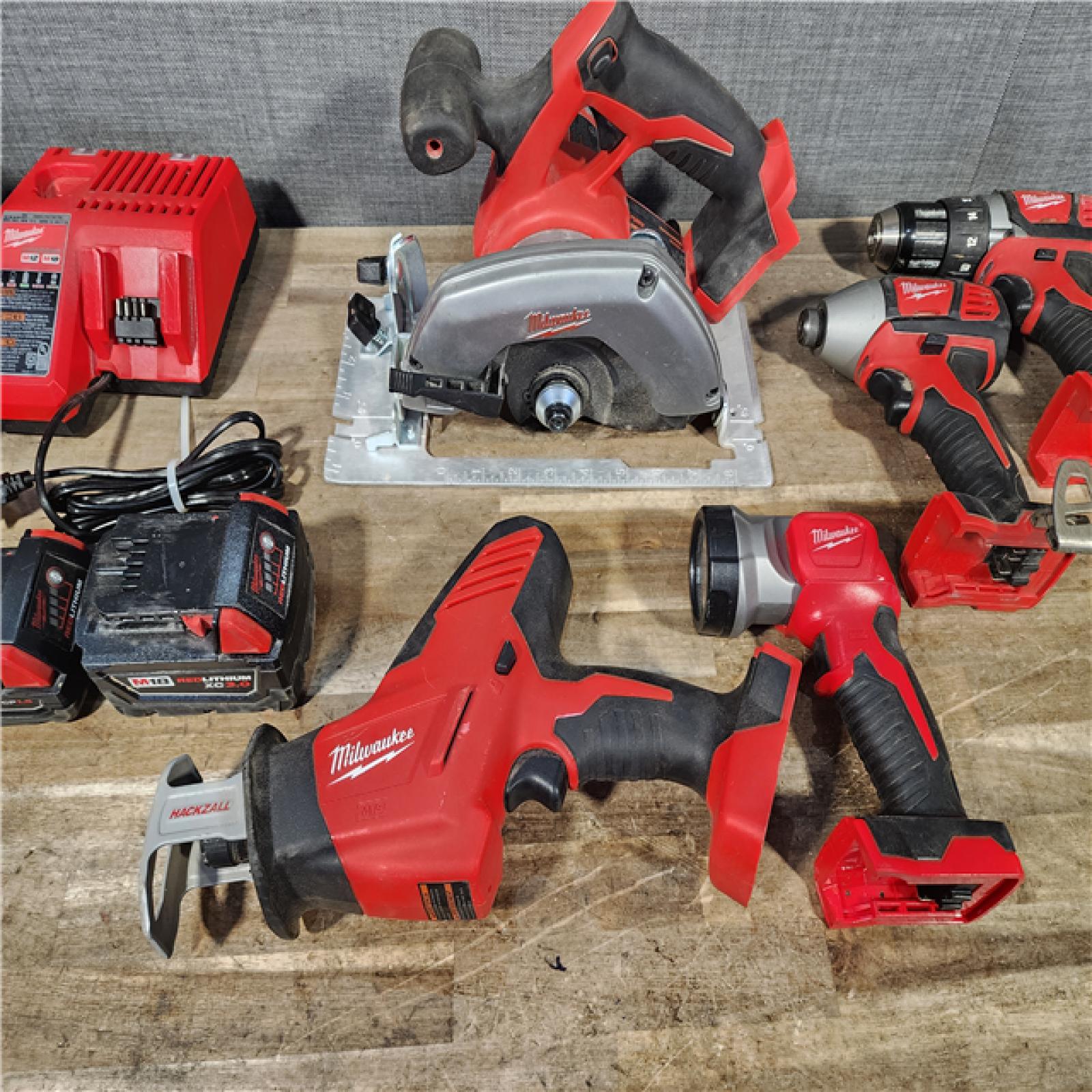 HOUSTON LOCATION - AS-IS Milwaukee M18 18-Volt Lithium-Ion Cordless Combo Tool Kit (5-Tool) with (1) 3.0Ah and (1) 1.5Ah Battery  (1) Charger  (1) Tool Bag