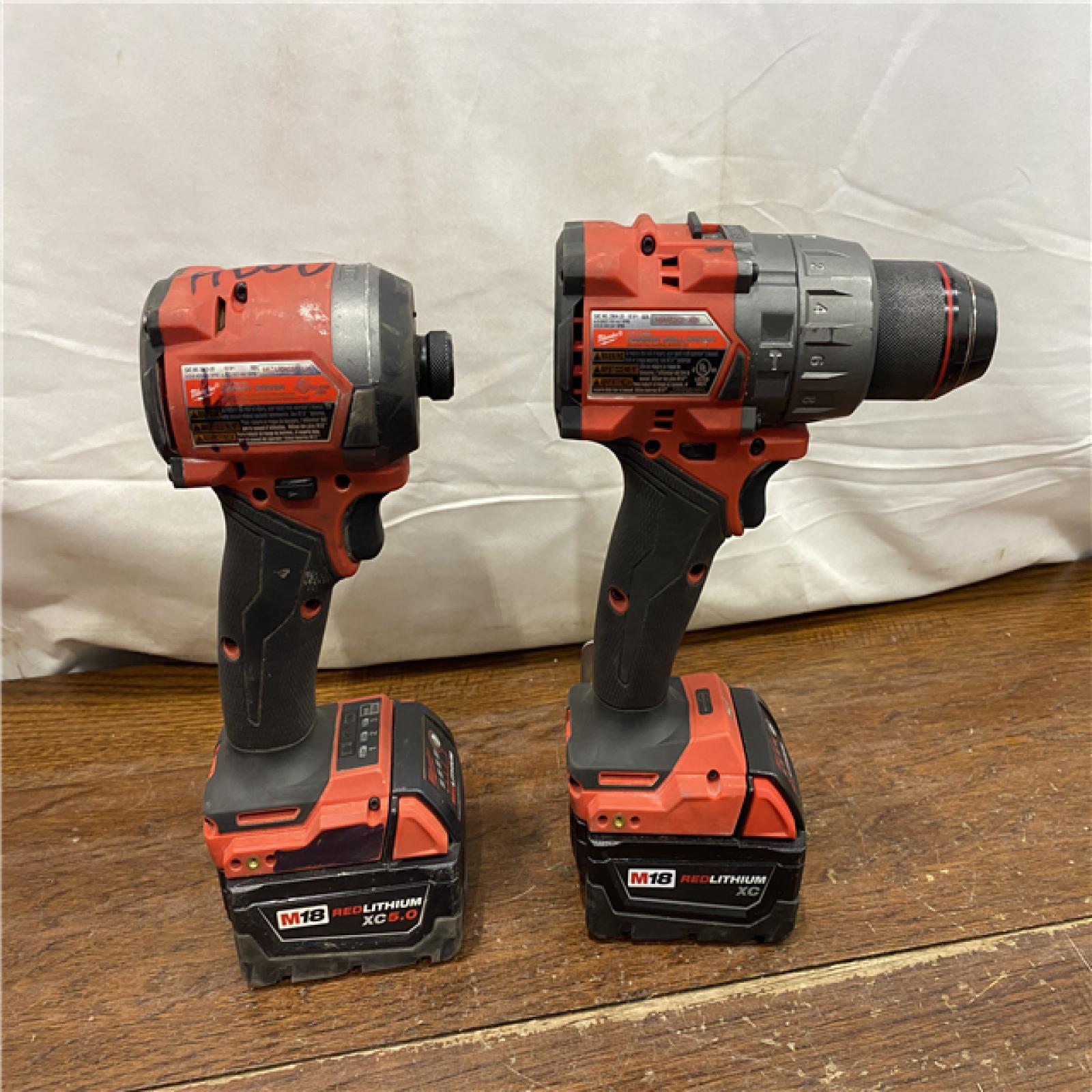 AS-IS MILWAUKEE M18 FUEL 18V Lithium-Ion Brushless Cordless Hammer Drill and Impact Driver Combo Kit (2-Tool) with 2 Batteries