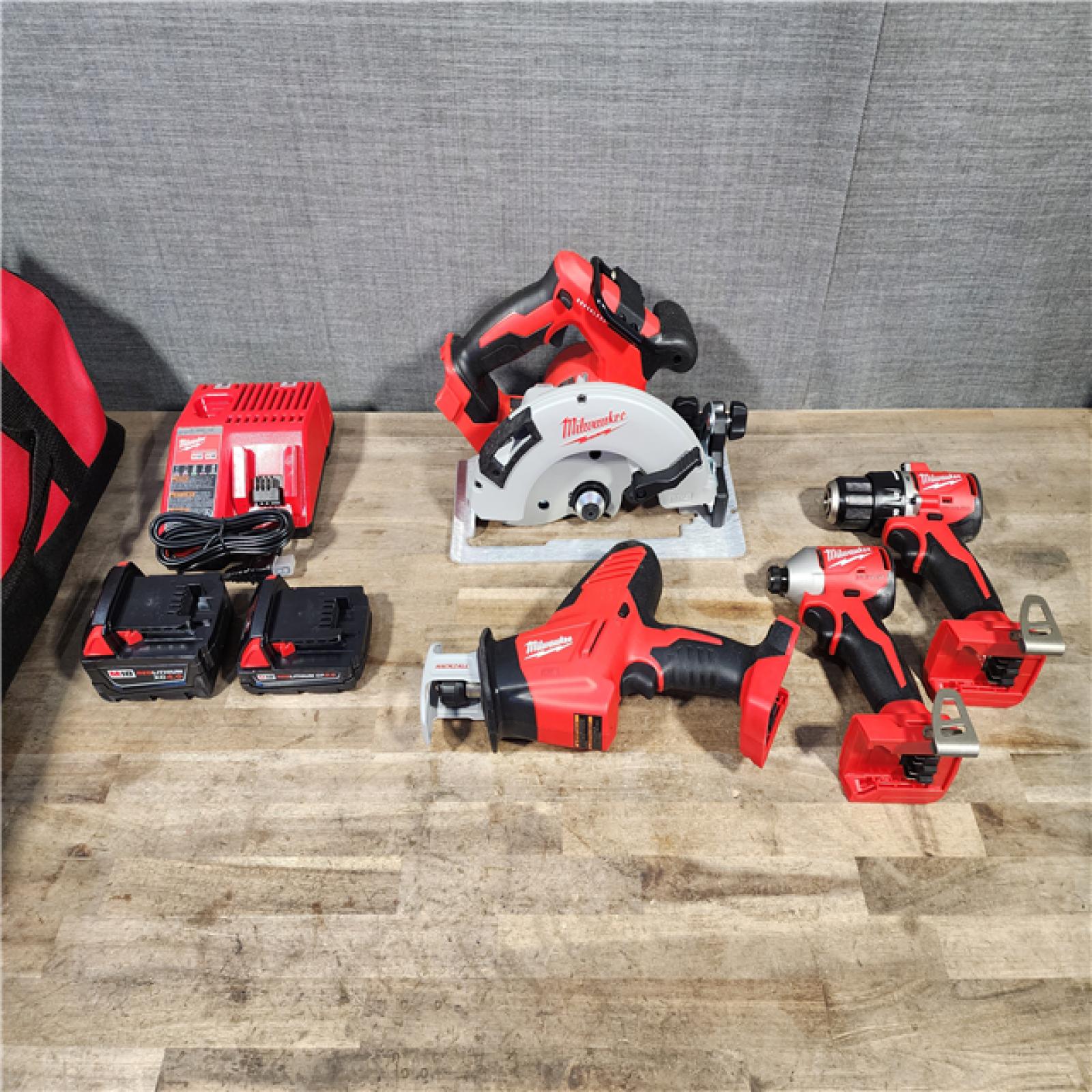 HOUSTON LOCATION - AS-IS Milwaukee M18 18-Volt Lithium-Ion Brushless Cordless Combo Kit (4-Tool) with 2-Batteries  1-Charger and Tool Bag