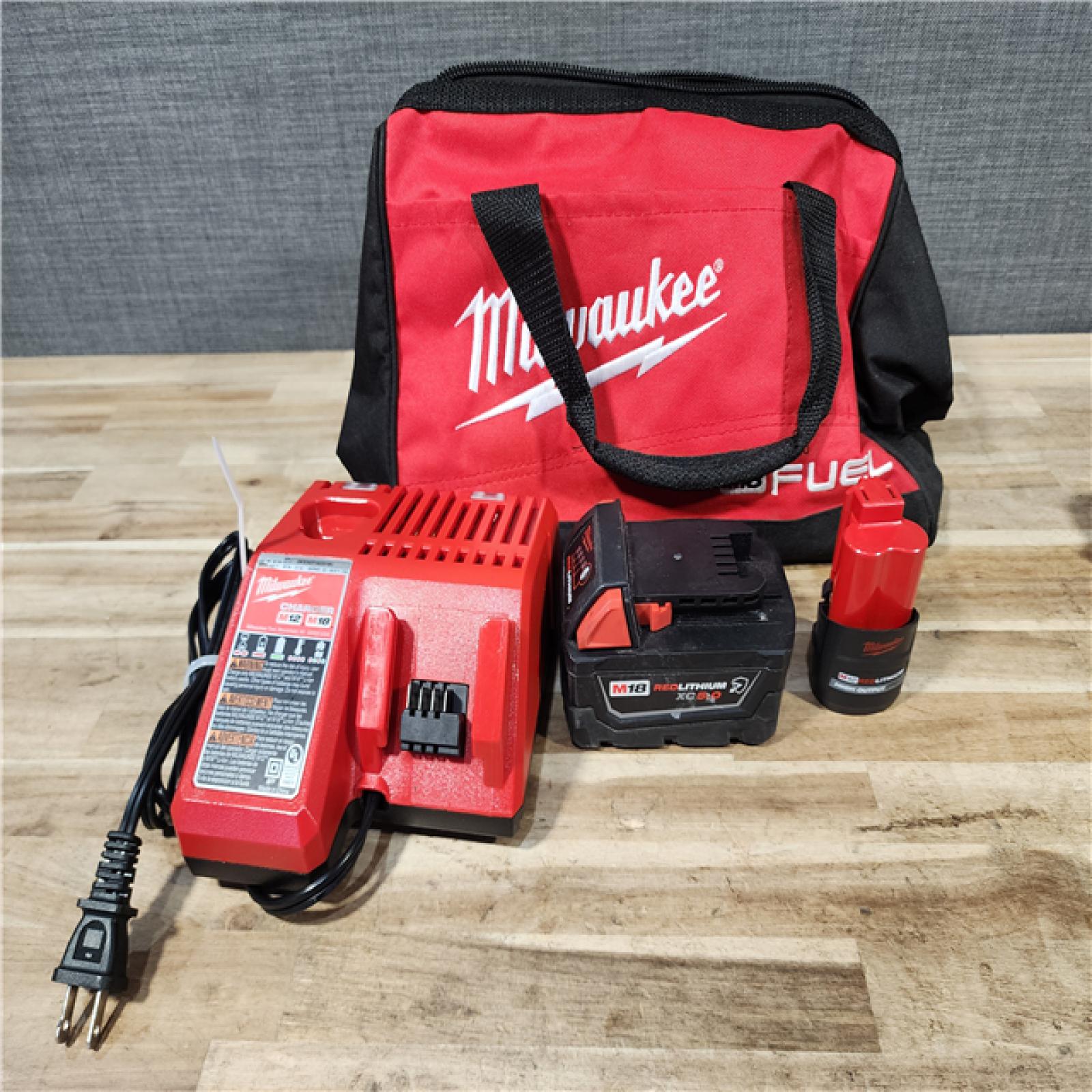HOUSTON LOCATION - AS-IS MILWAUKEE 2 TOOL COMBO KIT W/ (2) BATTERY & CHARGER