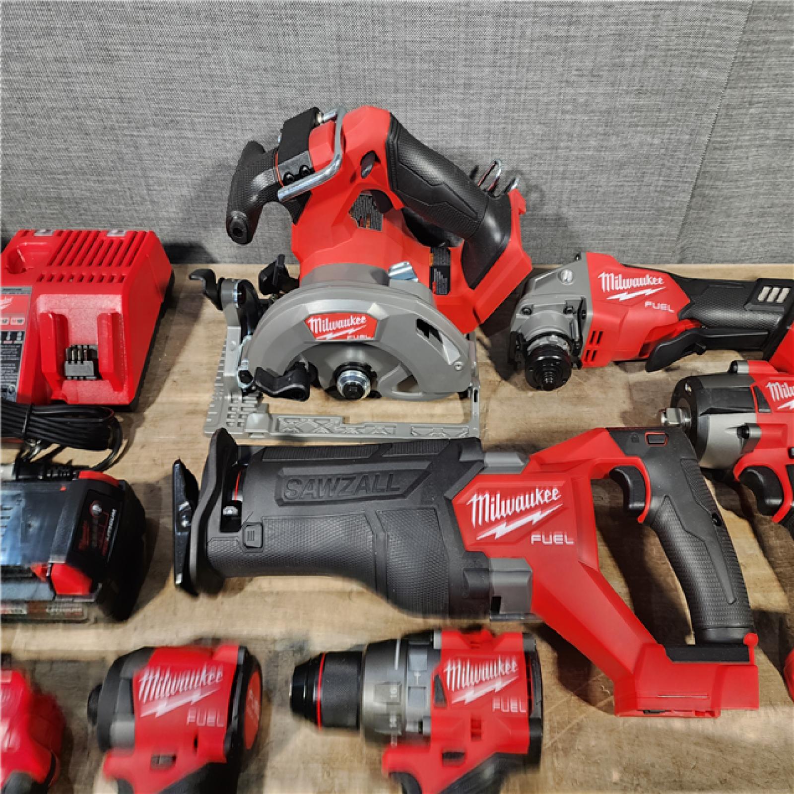 HOUSTON LOCATION - AS-IS (APPEARS LIKE NEW) Milwaukee M18 FUEL 18V Lithium-Ion Brushless Cordless Combo Kit with Two 5.0 Ah Batteries  1 Charger  2 Tool Bags (7-Tool)