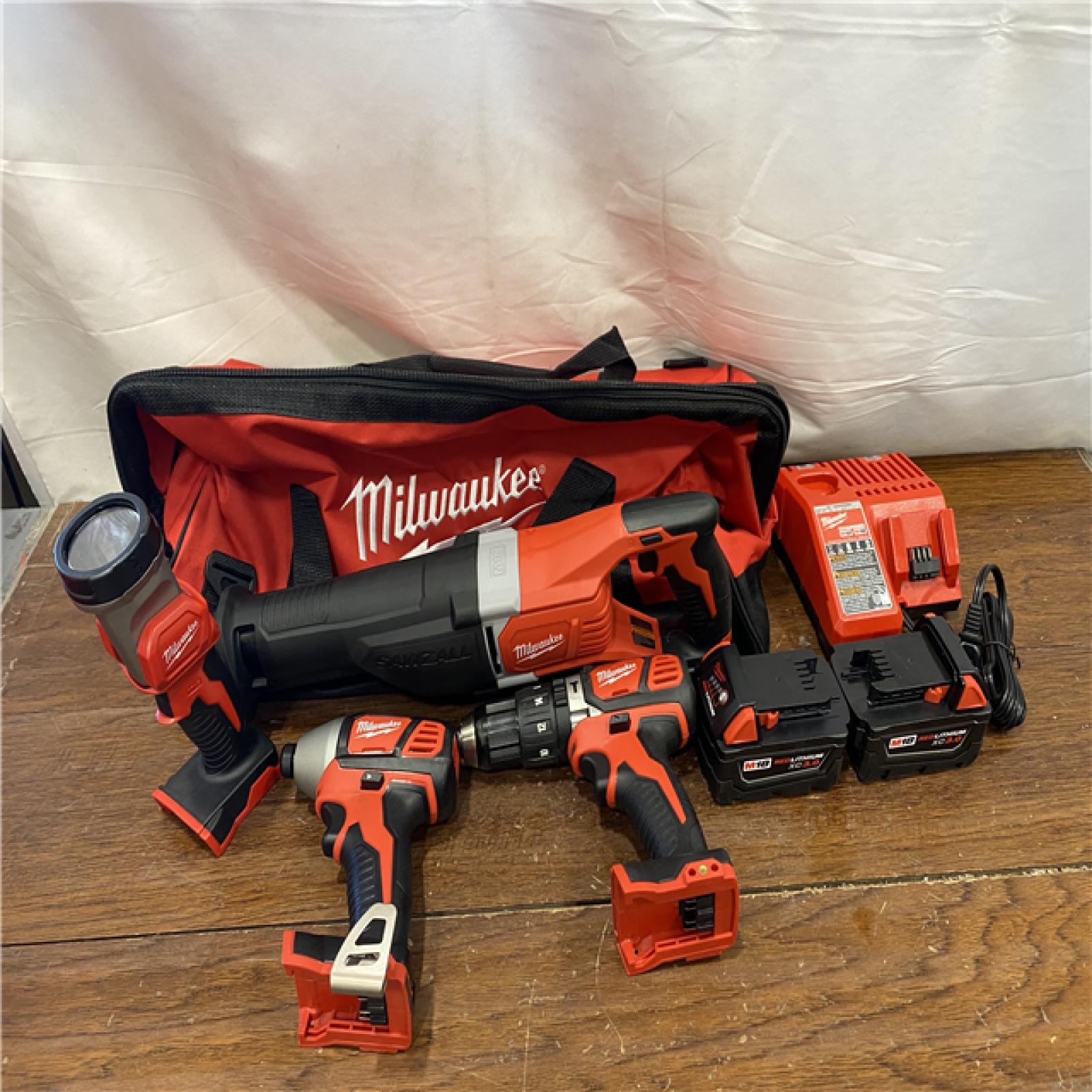 AS-IS MILWAUKEE M18 18V Lithium-Ion Cordless Combo Tool Kit with Two 3.0Ah Batteries, 1-Charger, 1-Tool Bag (4-Tool)