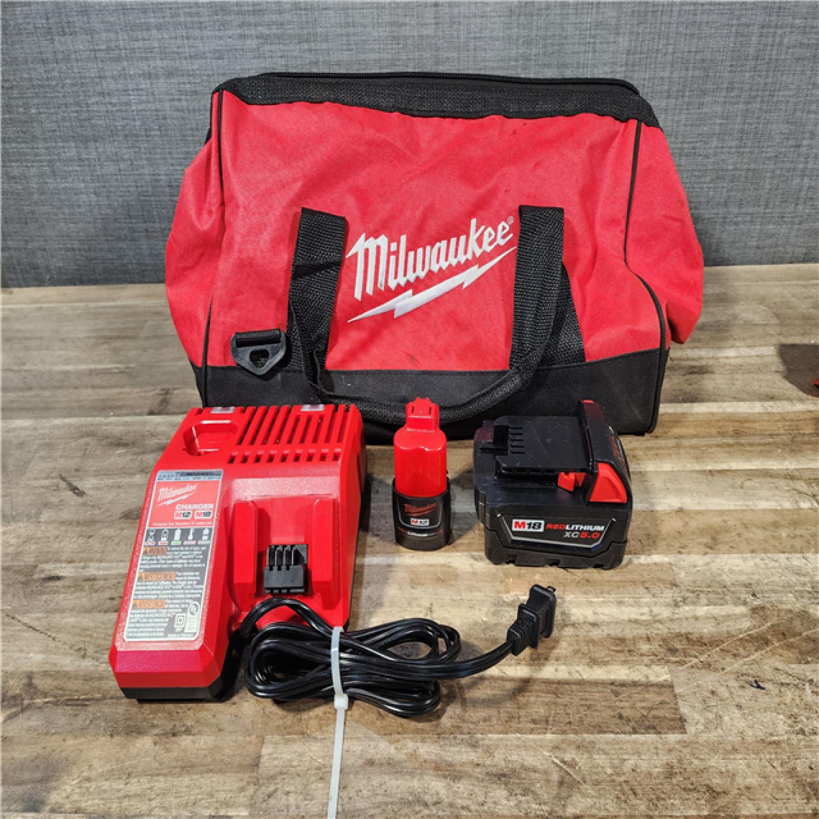HOUSTON LOCATION - AS-IS Milwaukee 12/18V Lithium-Ion Cordless 3/8 in. Ratchet and 1/2 in. High Torque Impact Wrench with Friction Ring Combo Kit