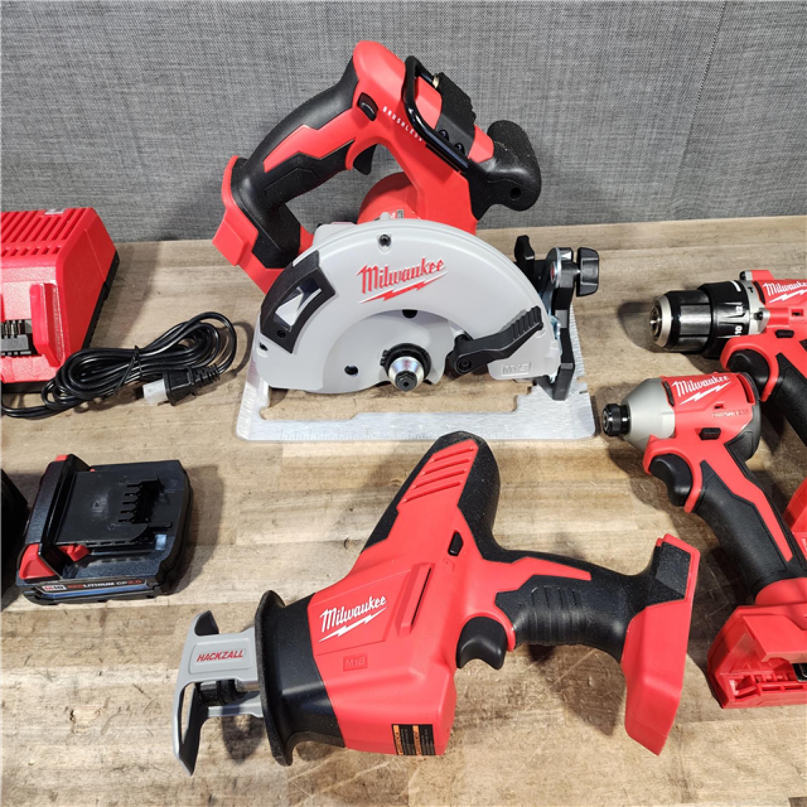 HOUSTON LOCATION - AS-IS Milwaukee M18 18-Volt Lithium-Ion Brushless Cordless Combo Kit (4-Tool) with 2-Batteries  1-Charger and Tool Bag