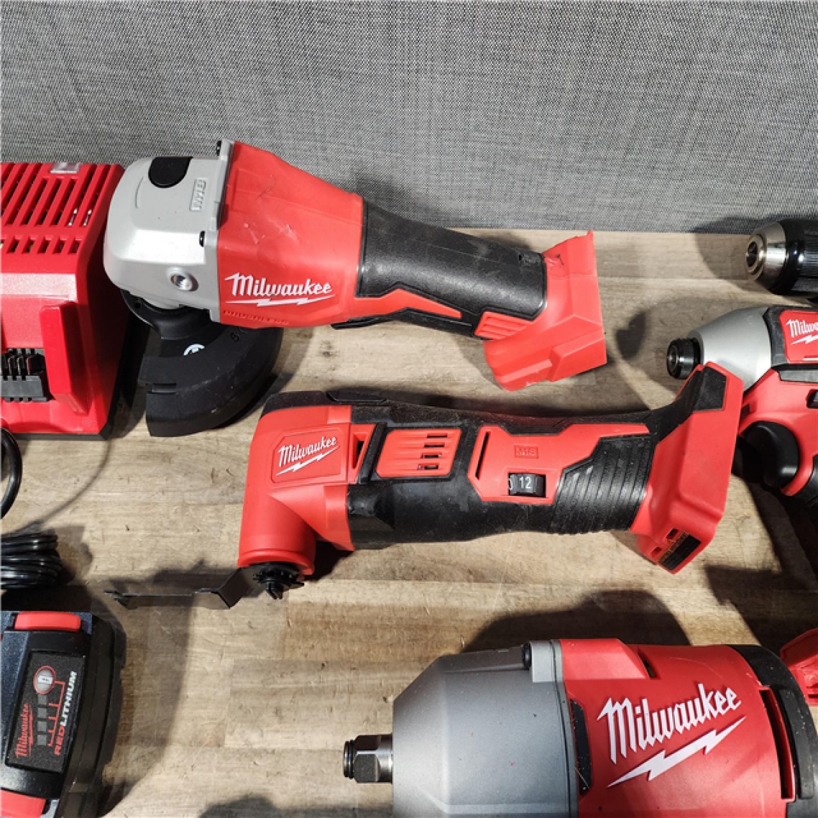 HOUSTON LOCATION - AS-IS MILWAUKEE 7 TOOL COMBO KIT W/ (2) BATTERY & CHARGER