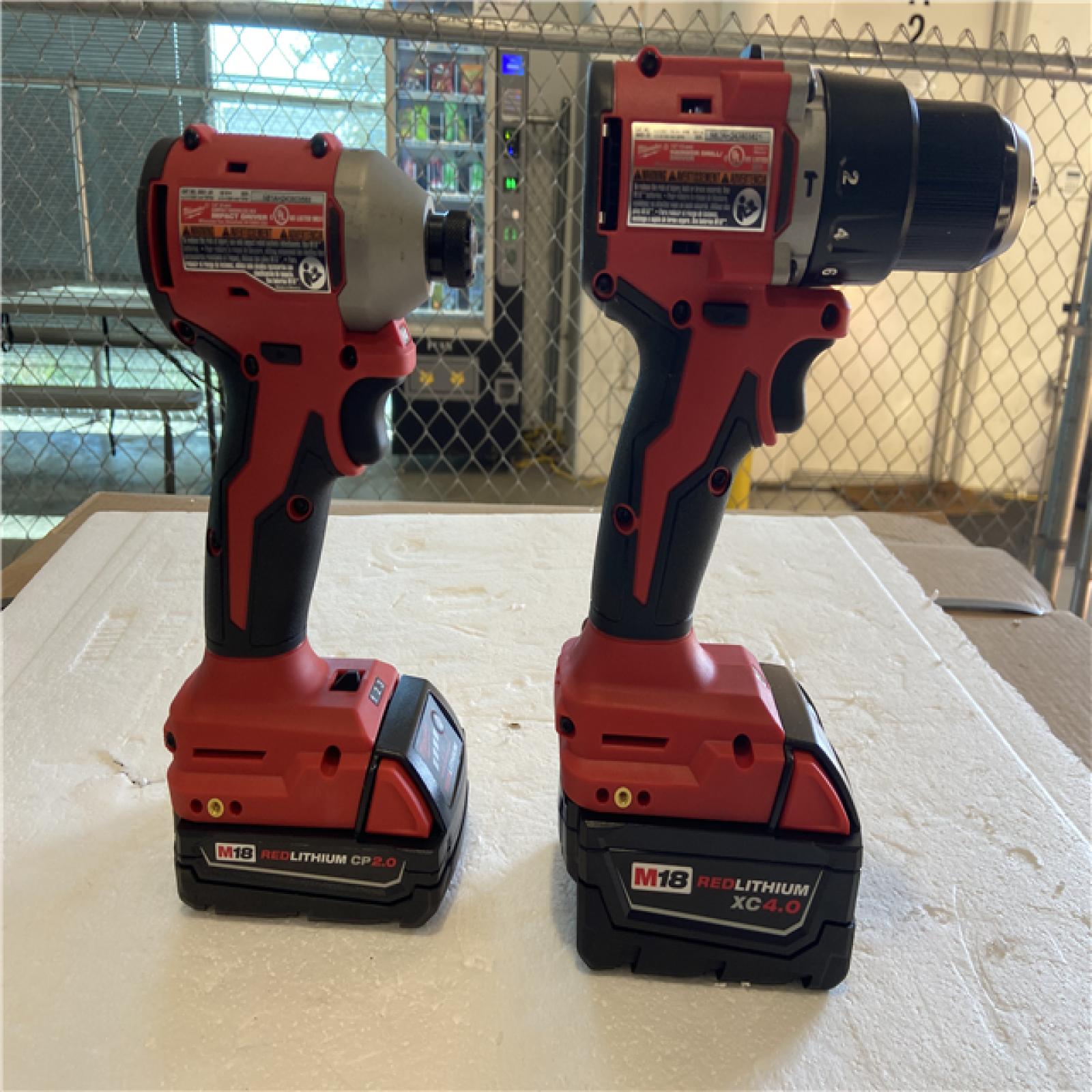 AS-IS M18 18-Volt Lithium-Ion Brushless Cordless Compact Hammer Drill/Impact Combo Kit (2-Tool) with (2) Batteries, Bag