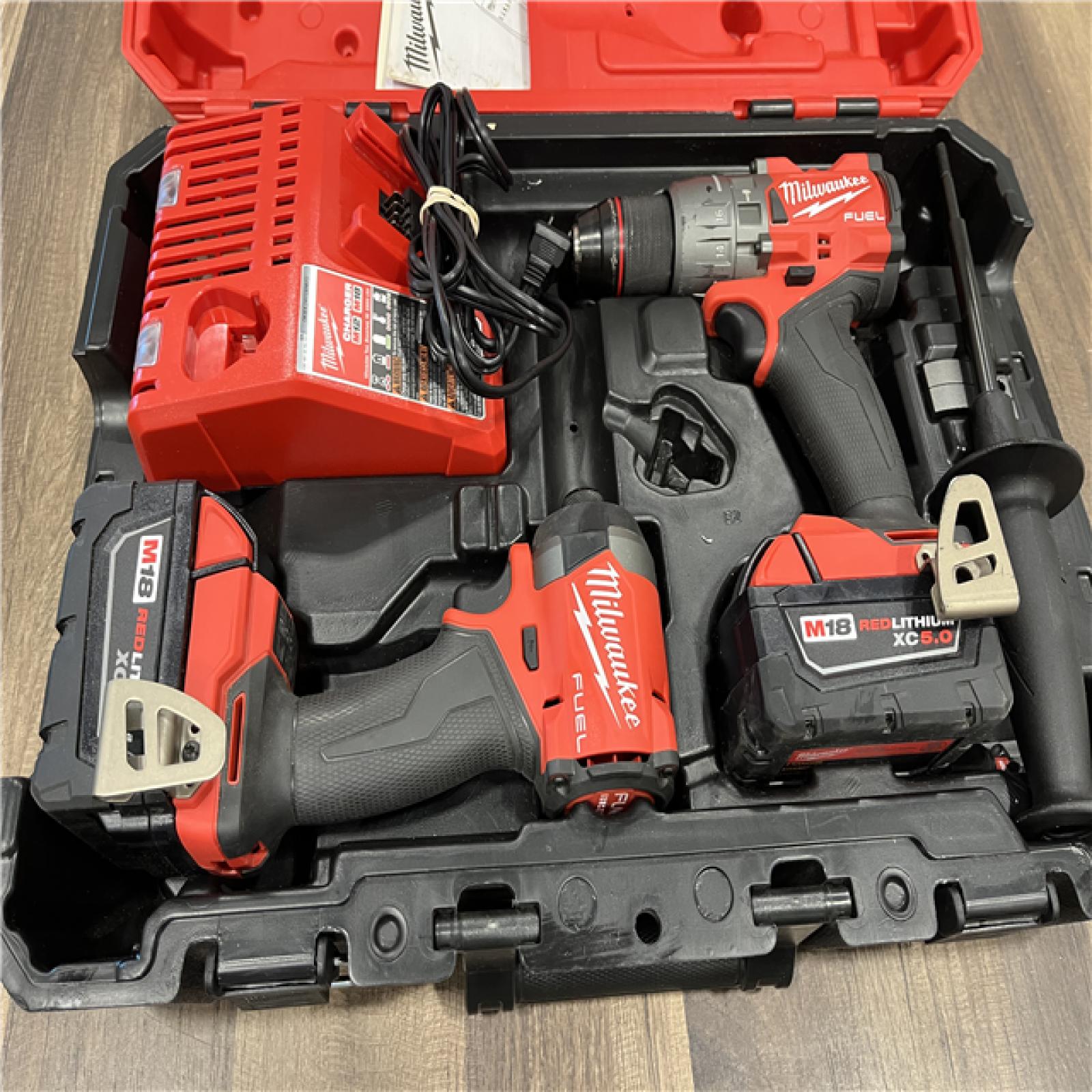 AS-IS MILWAUKEE FUEL 18V Lithium-Ion Brushless Cordless Hammer Drill and Impact Driver Combo Kit (2-Tool) with 2 Batteries