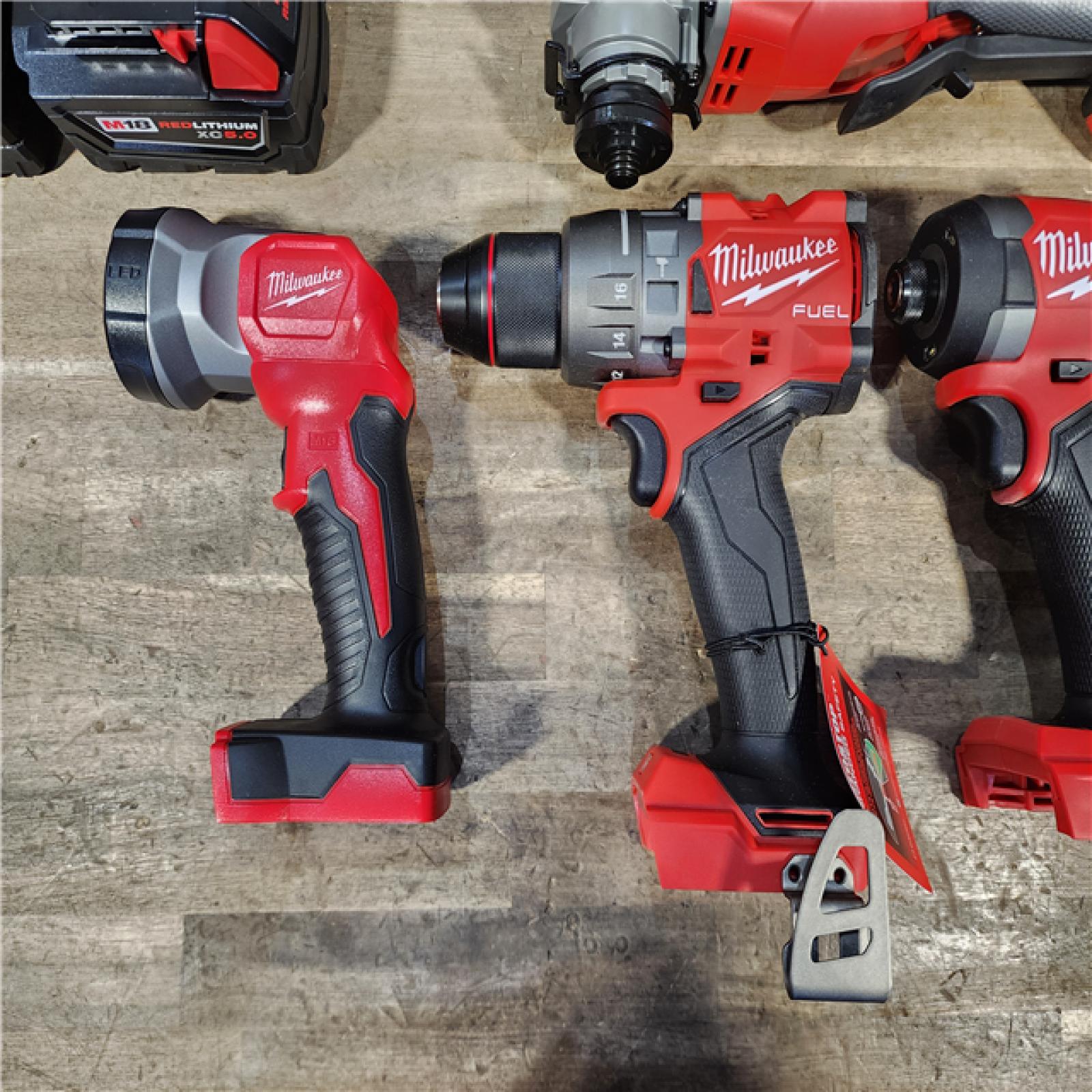HOUSTON LOCATION - AS-IS (APPEARS LIKE NEW) Milwaukee M18 FUEL 18V Lithium-Ion Brushless Cordless Combo Kit with Two 5.0 Ah Batteries  1 Charger  2 Tool Bags (7-Tool)